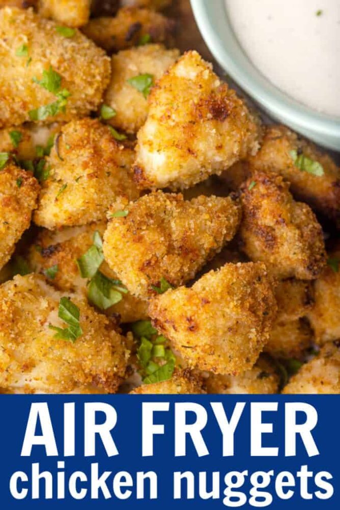 Nuggets de pollo en un plato junto a un plato de aderezo ranch.